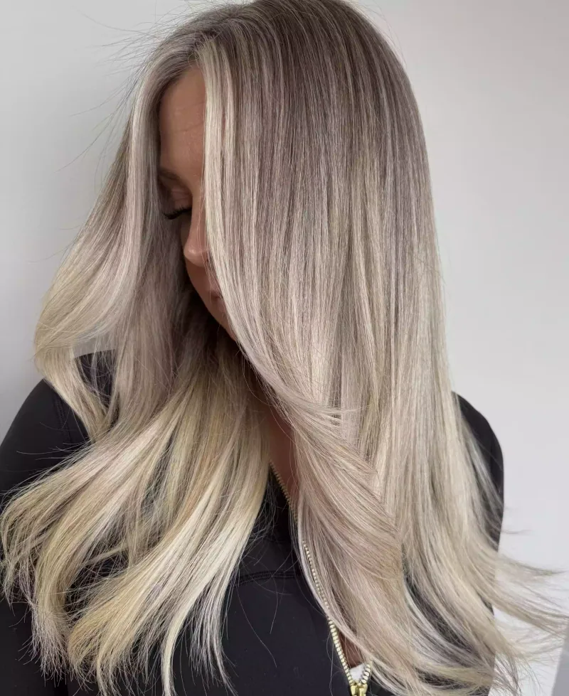 Long ash-blonde hair with dimensional highlights and soft waves
