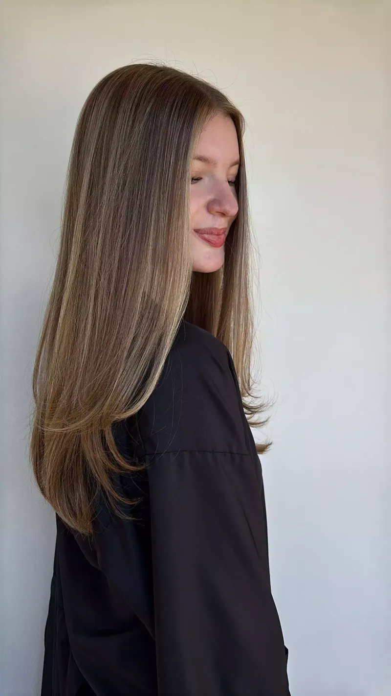Long, sleek bronde blowout with face-framing layers
