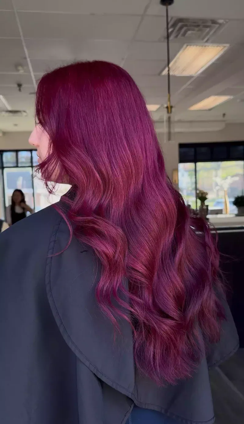 Vibrant magenta color on long, glossy waves